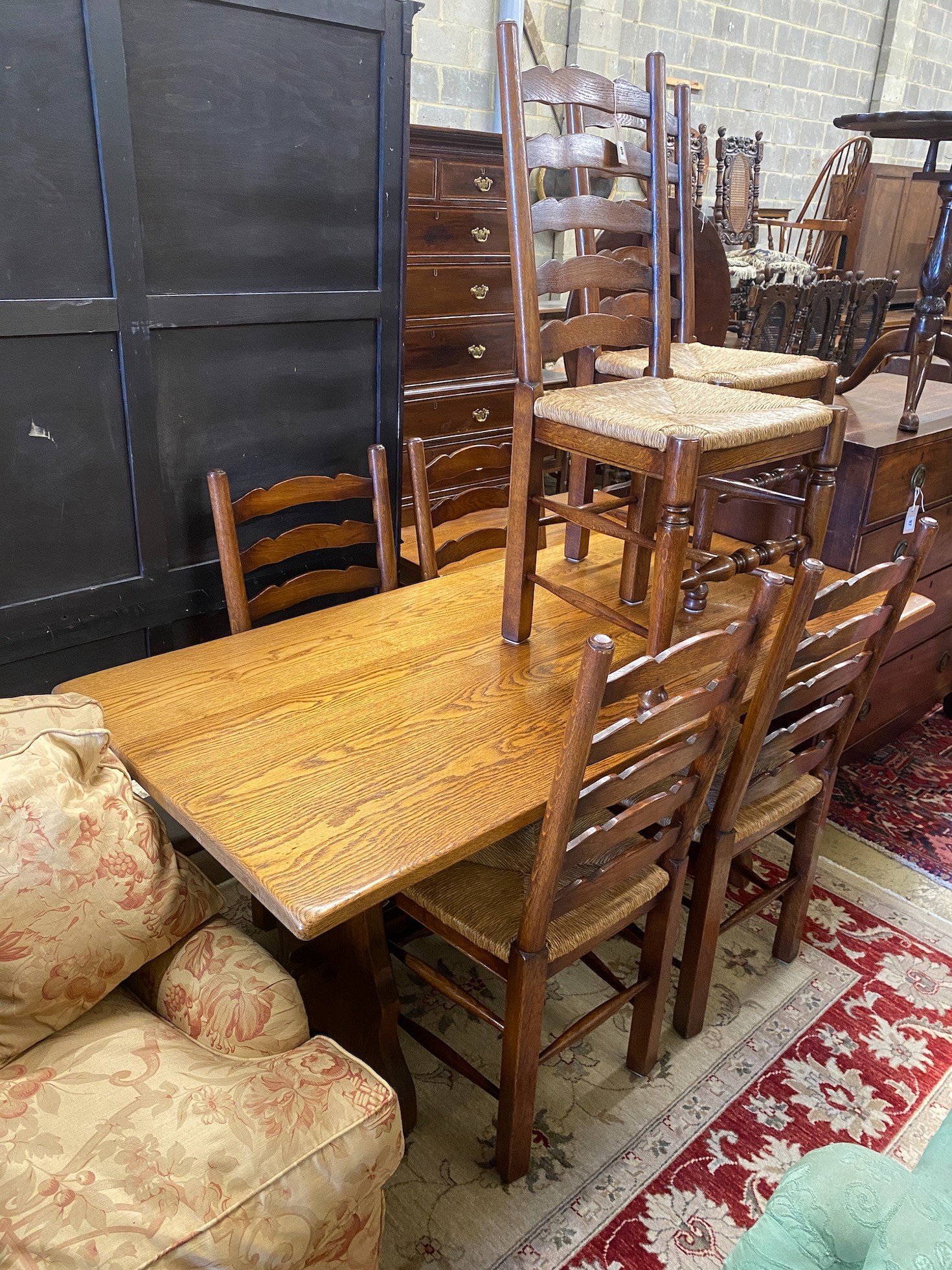 An 18th century style rectangular oak refectory dining table, length 167cm, depth 78cm, height 74cm and six ladderback rush seat dining chairs